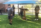 Living Word Church Pastor Albert Toralez delivers words Saturday evening, in the park across from his church, protesting COVID-19 guidelines aimed at indoor church services. 